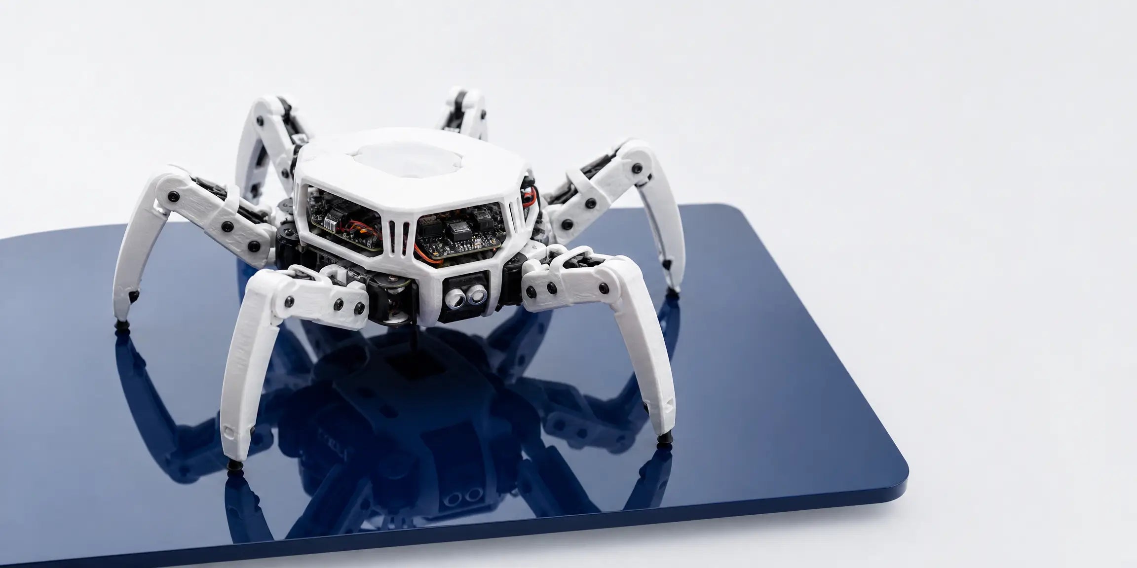 3D printed white hexapod robot chassis with integrated electronics, showcasing LANDU filament applications for robotics and DIY maker projects.