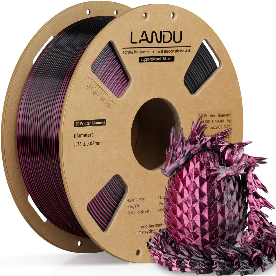 LANDU Red and Black Dual Color Silk PLA 3D printer filament 1kg spool alongside a high contrast 3D printed color shifting dragon and egg.