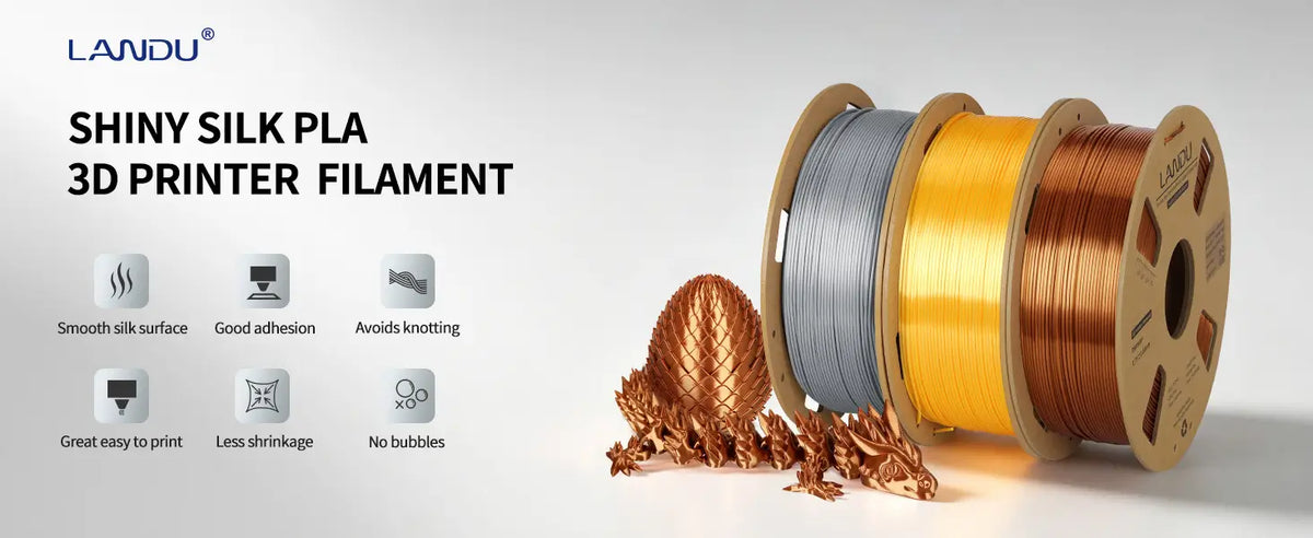 LANDU Shiny Silk PLA 3D printer filament spools in silver, gold, and copper alongside a 3D printed articulated dragon.